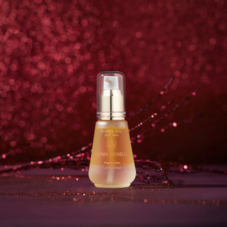 A bottle of Sonia Roselli Water Oil Skin Prep, a nourishing face oil, set on a shimmering red background